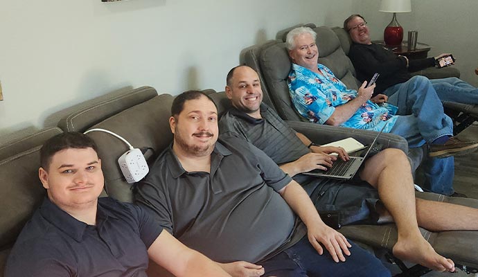 Group of people relaxing on reclining chairs in a home theater room