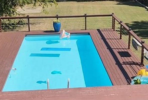 An overhead view of a rectangular, above-ground swimming pool.