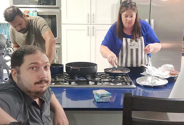 People preparing food together in a modern kitchen.