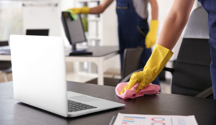 Person cleaning a office with equipment