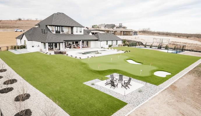 High-end residential backyard with professional synthetic grass and putting green