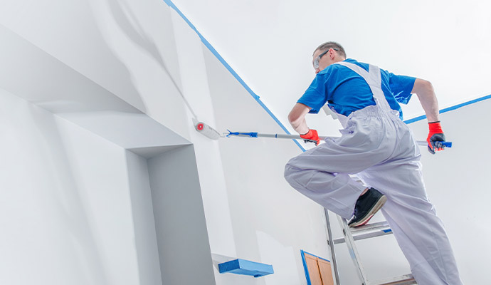 Person painting wall professionally