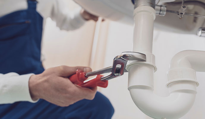 A plumber fixing sink pipe